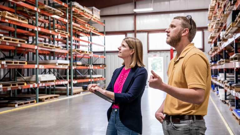 man and woman standing in warehouse